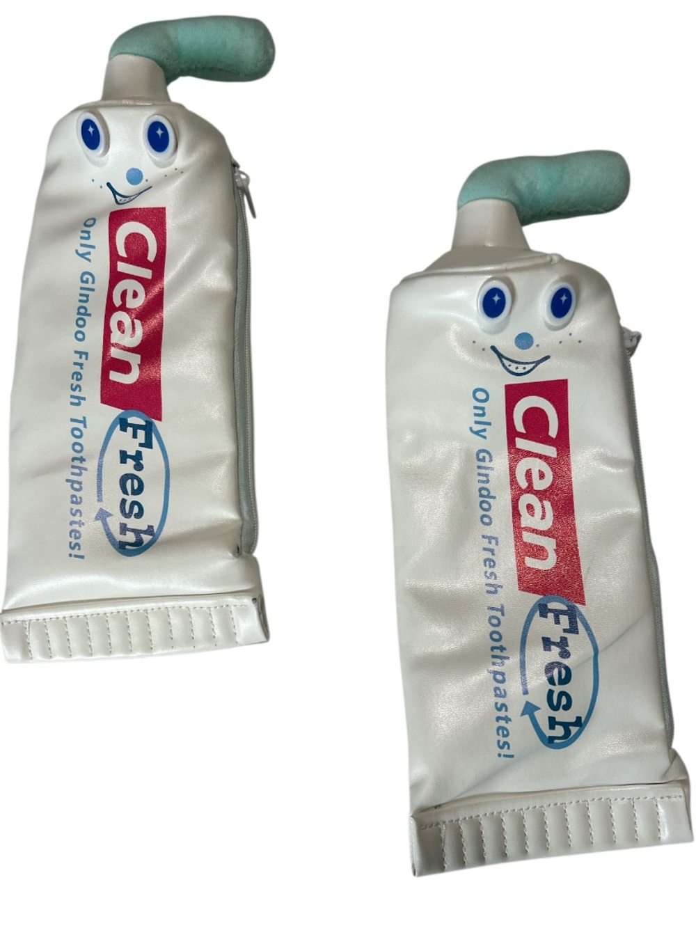 Two White Toothpaste Tube with zipper closure.